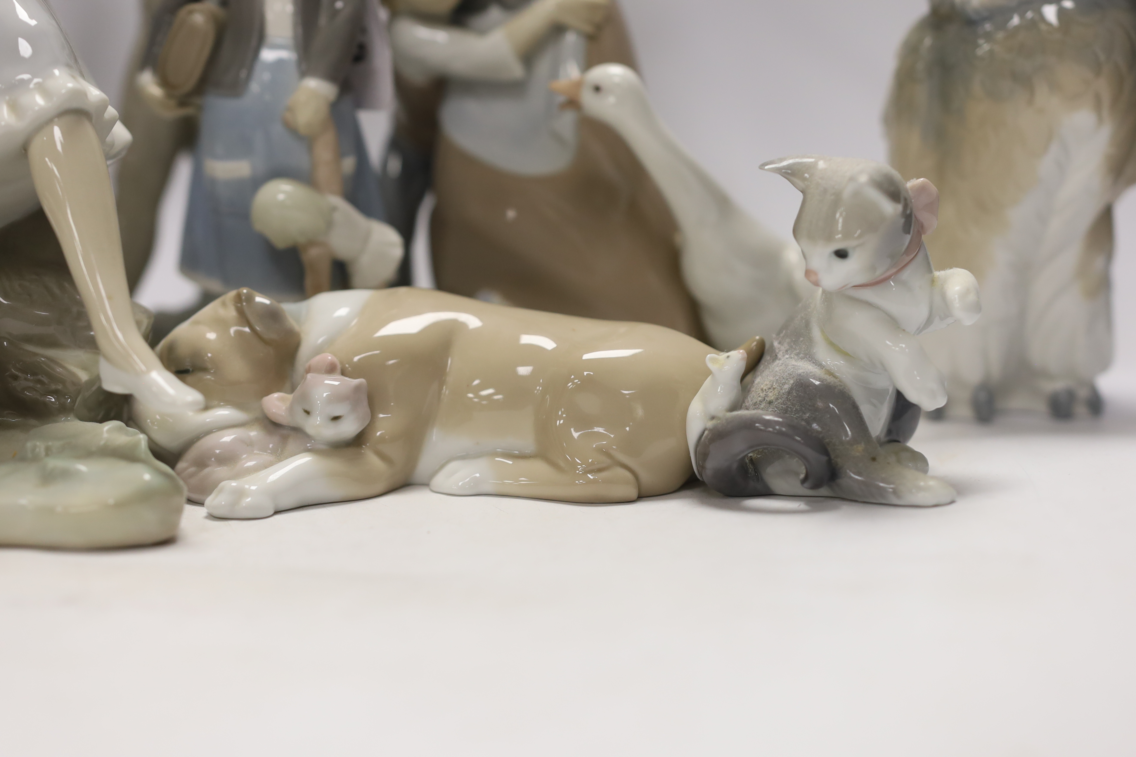 Ten Lladro and Nao figures including a short eared owl and a girl with braids, largest 26cm high